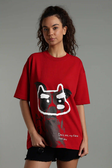 A woman wearing a red fool face oversized unisex dog print t-shirt with a graphic design on a gray background