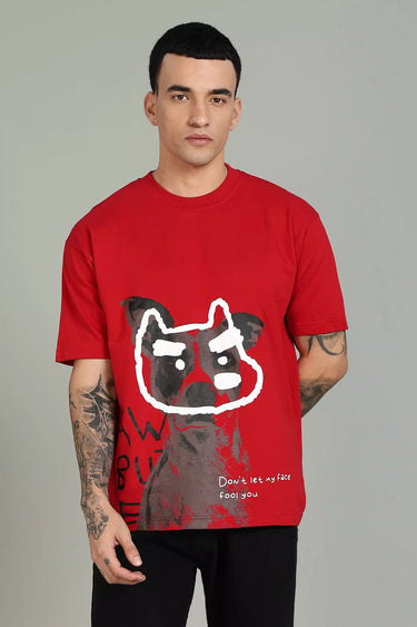 Man wearing a red fool face unisex oversized dog printed t-shirt with a graphic design on a gray background