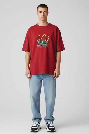 Red oversized graphic t-shirt with colorful vintage style print, paired with light blue jeans and sneakers.