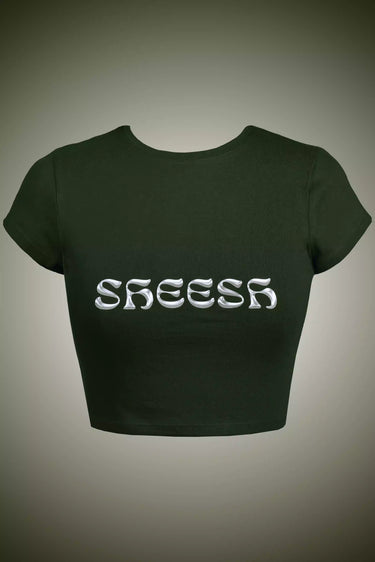 Olive green crop top with 'SHEESH' text on a gray background