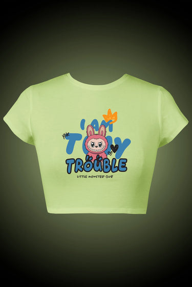 Light green crop top with 'I am Tiny Trouble' and a labubu graphic on a dark background